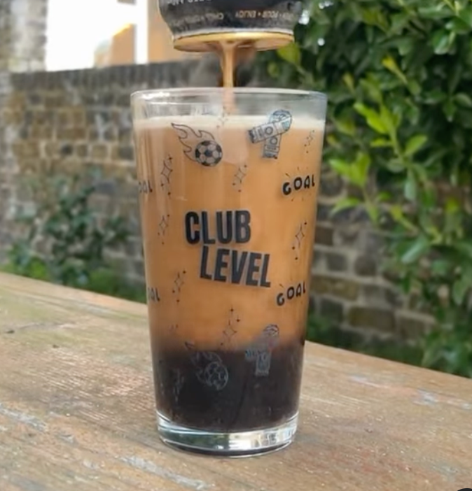 Pouring a beer into a Club Level Collective Pint Glass for Women's Football Fans