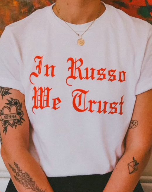 Woman with tattoos wearing a In Russo We Trust White T-Shirt
