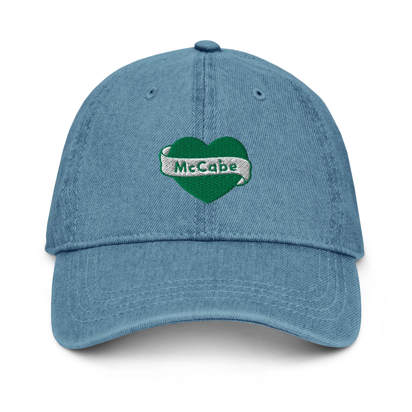 Denim hat with a green Katie McCabe heart graphic embroidered on it